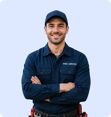 Smiling HVAC technician wearing navy cap and uniform, arms crossed, with tool belt on light blue background.