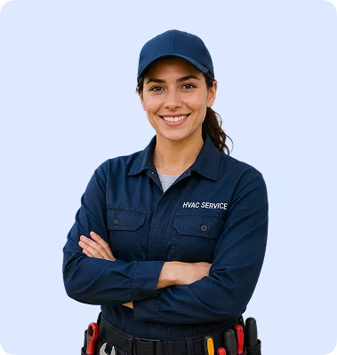 Smiling female HVAC technician wearing navy cap and uniform, arms crossed, with tool belt.